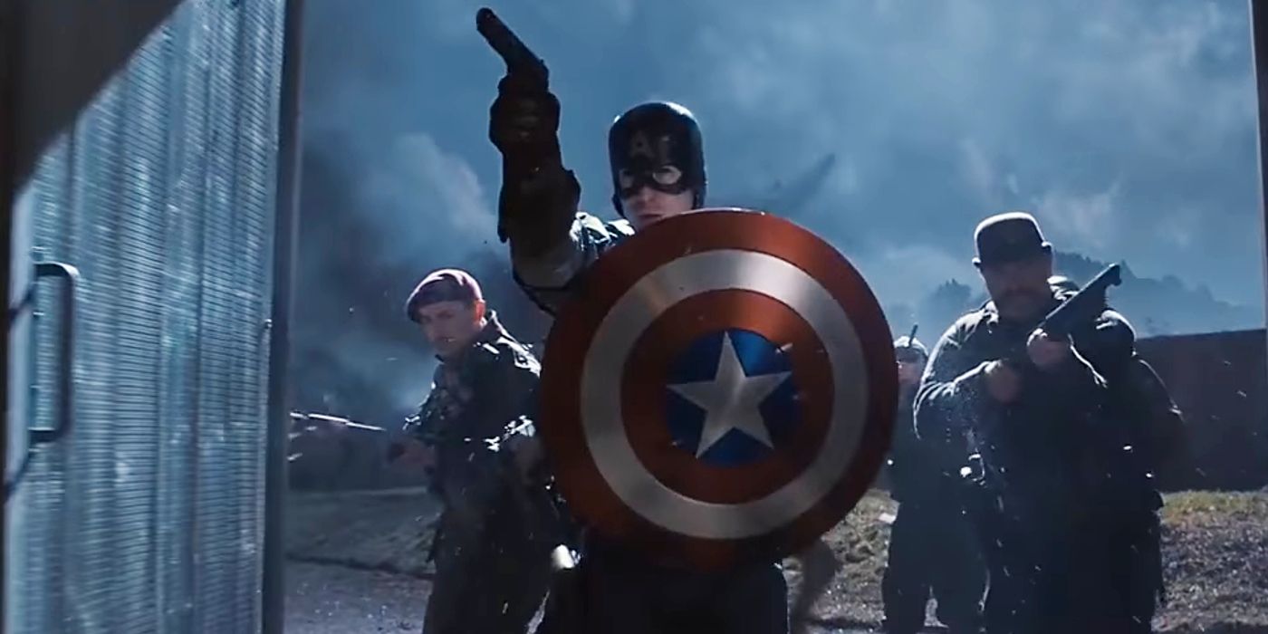 Captain America holds his shield in front of him as he leads soldiers into battle