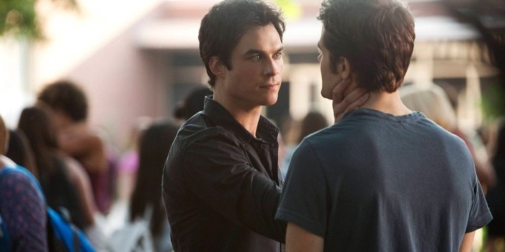 Damon grabs Stefan by the throat in the Vampire Diaries 