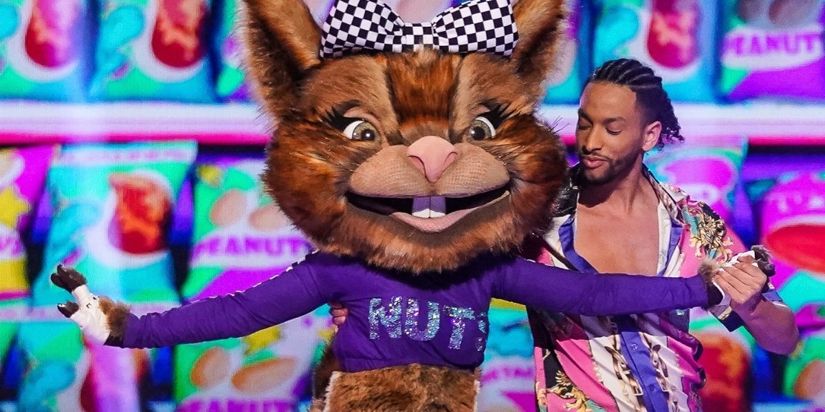 A dancer dancing with a costumed cat in Dance Monsters