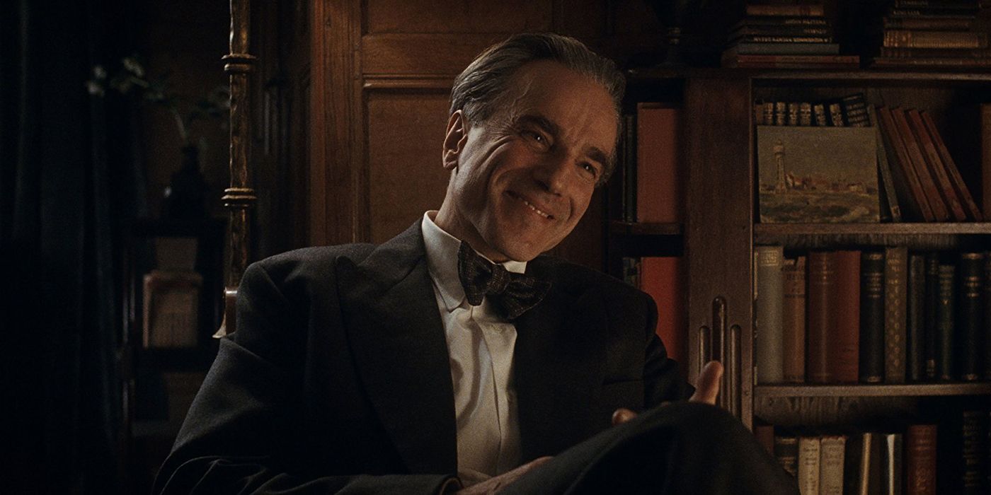 Reynolds Woodcock sitting in a chair and smiling in Phantom Thread.