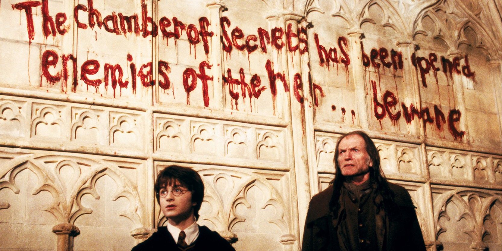Daniel Radcliffe as Harry Potter and David Bradley as Filch in The Chamber of Secrets