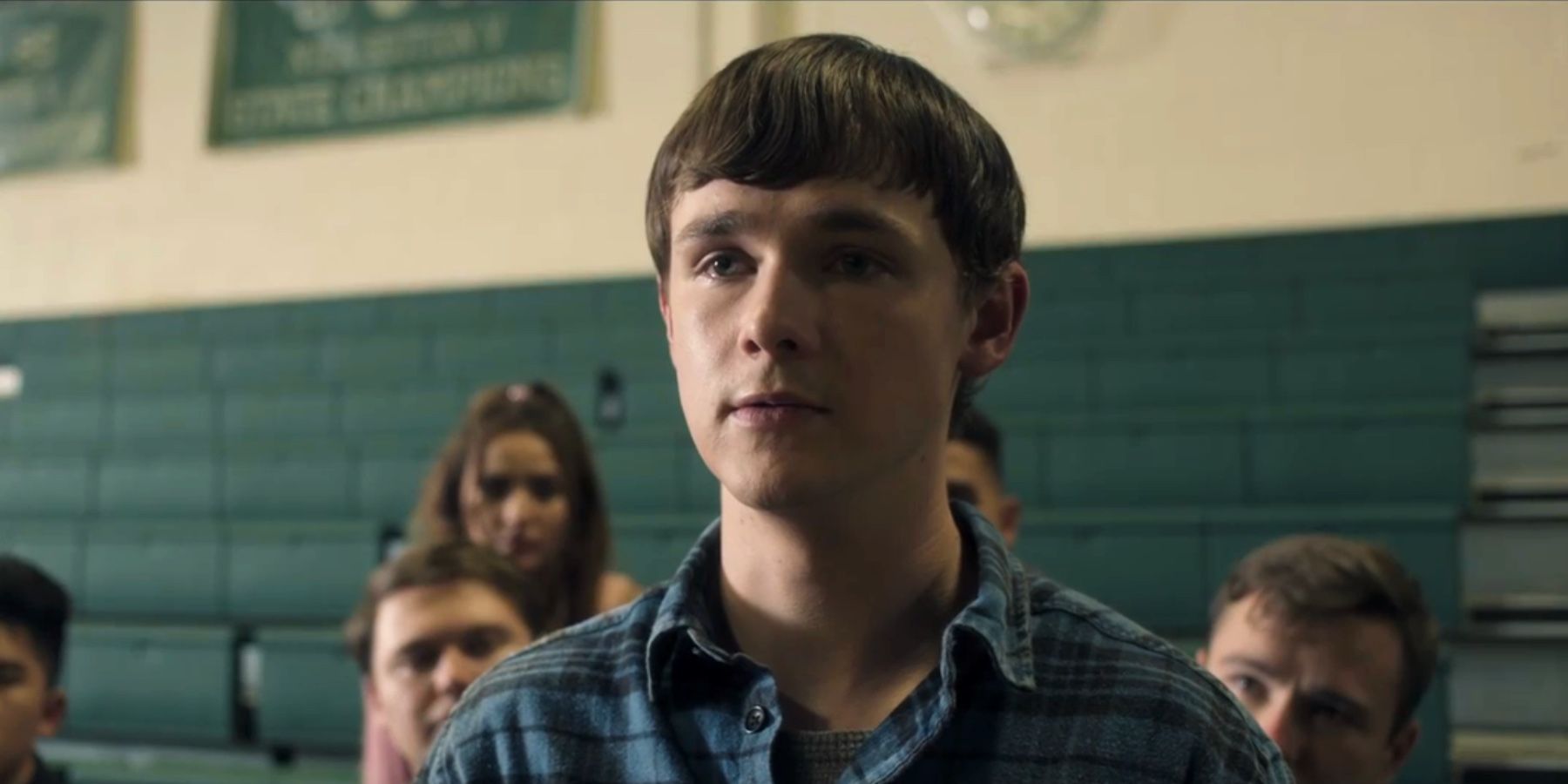 Harrison standing in the school gym assembly in a scene from Dexter: New Blood.