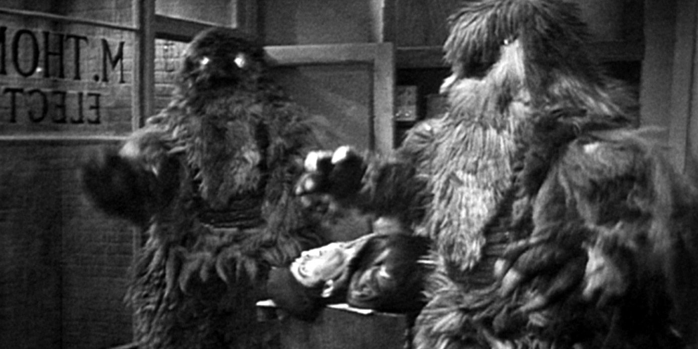 Two Yeti standing over a dead body in Doctor Who
