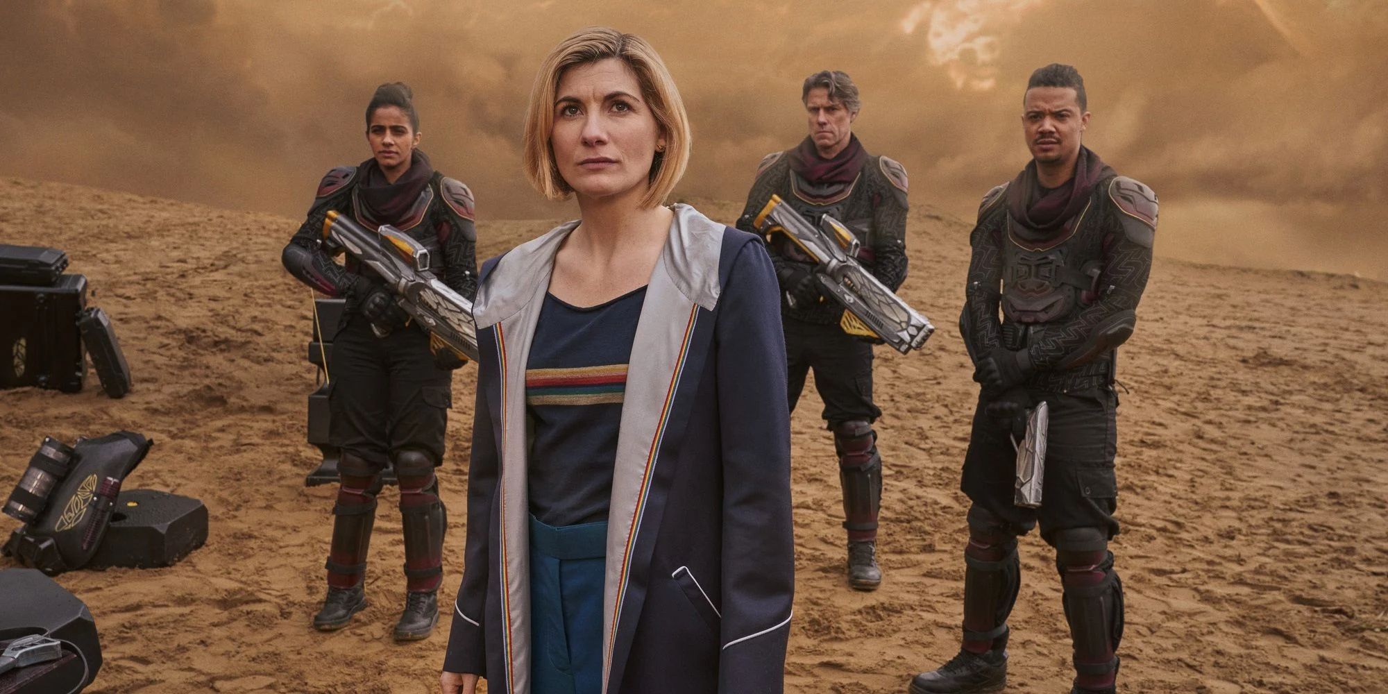 Doctor Who stands in front of men with guns from Doctor Who