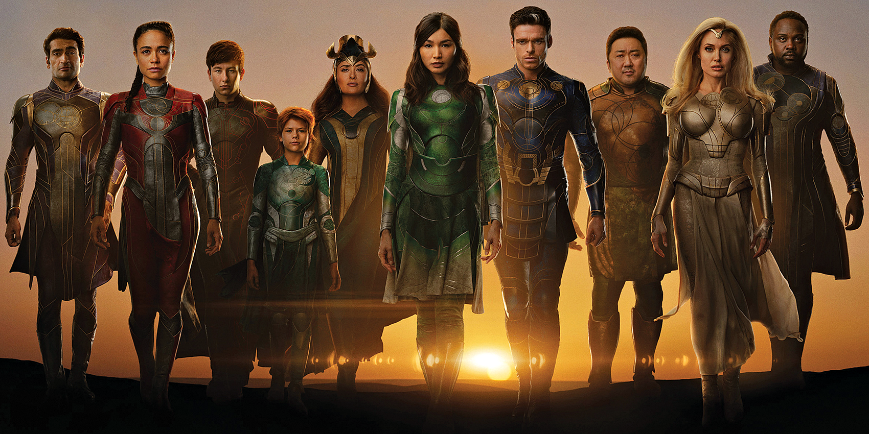 Eternals Cast side by side with the sun rising behind them