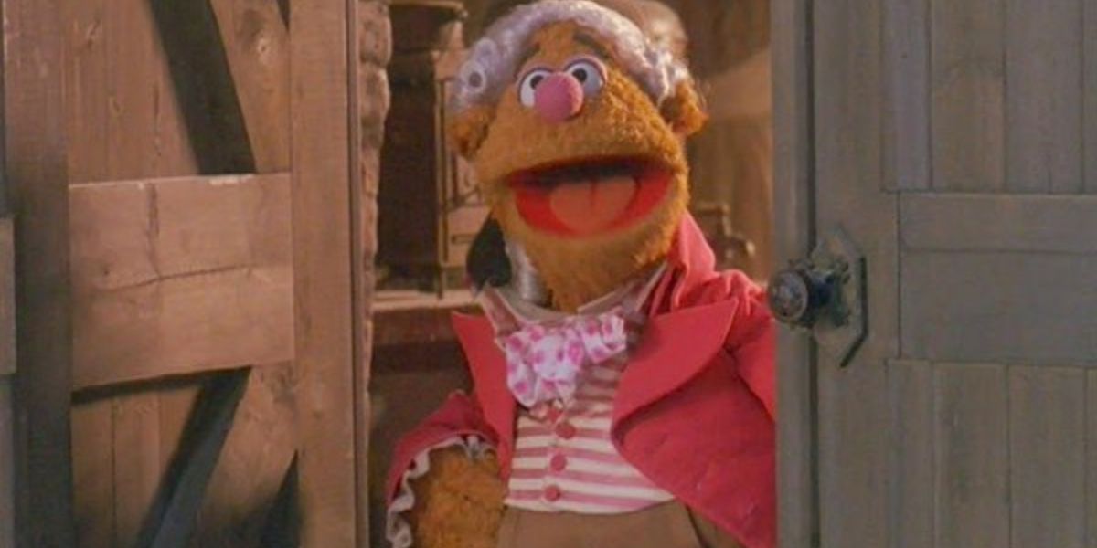 Mr. Fozziwig smiles at his door in The Muppet Christmas Carol.