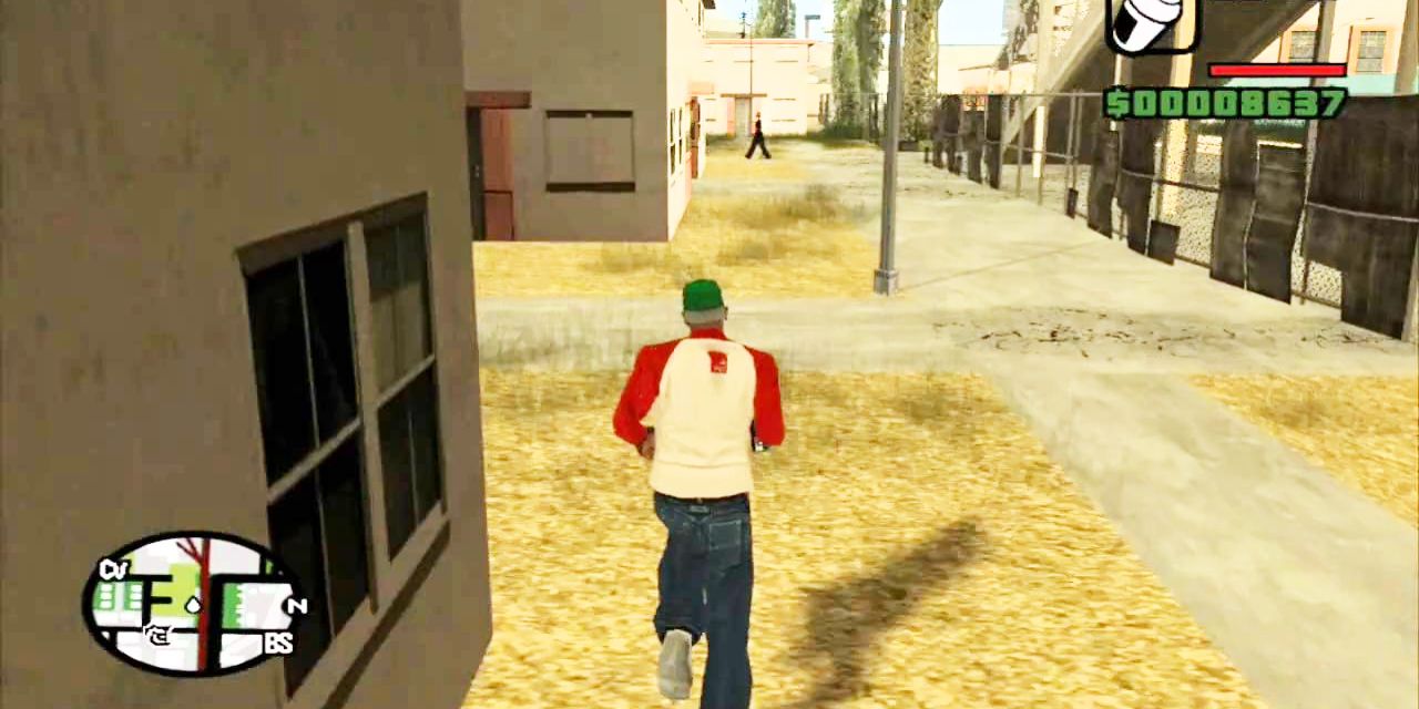 A man runs next to a house in Grand Theft Auto.