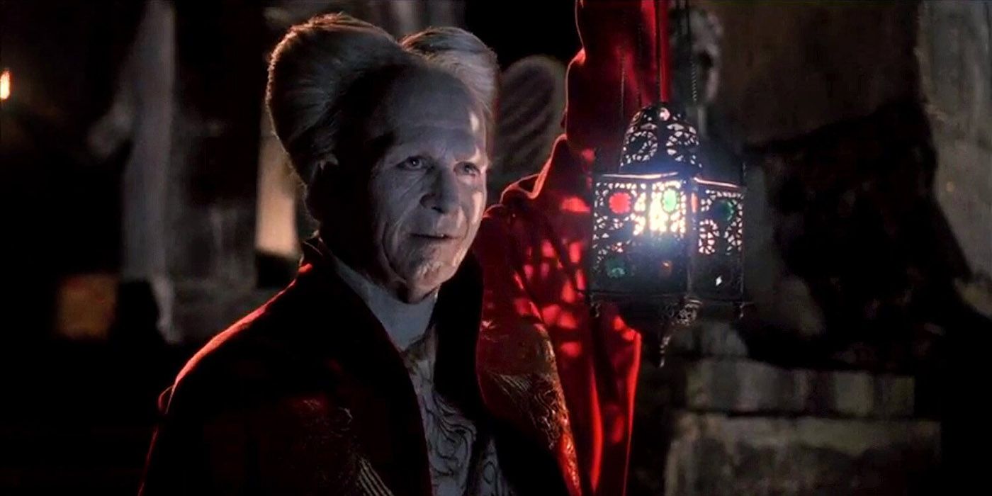 Gary Oldman as Dracula holding a lantern