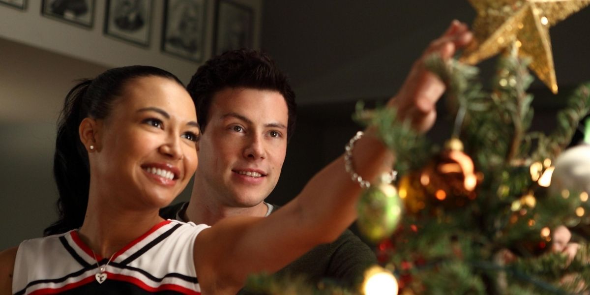 Finn and Santa putting the star on the tree in Glee