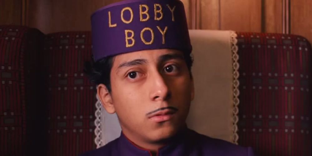 Close-up of Zero looking bemused in his Lobby Boy cap in The Grand Budapest Hotel