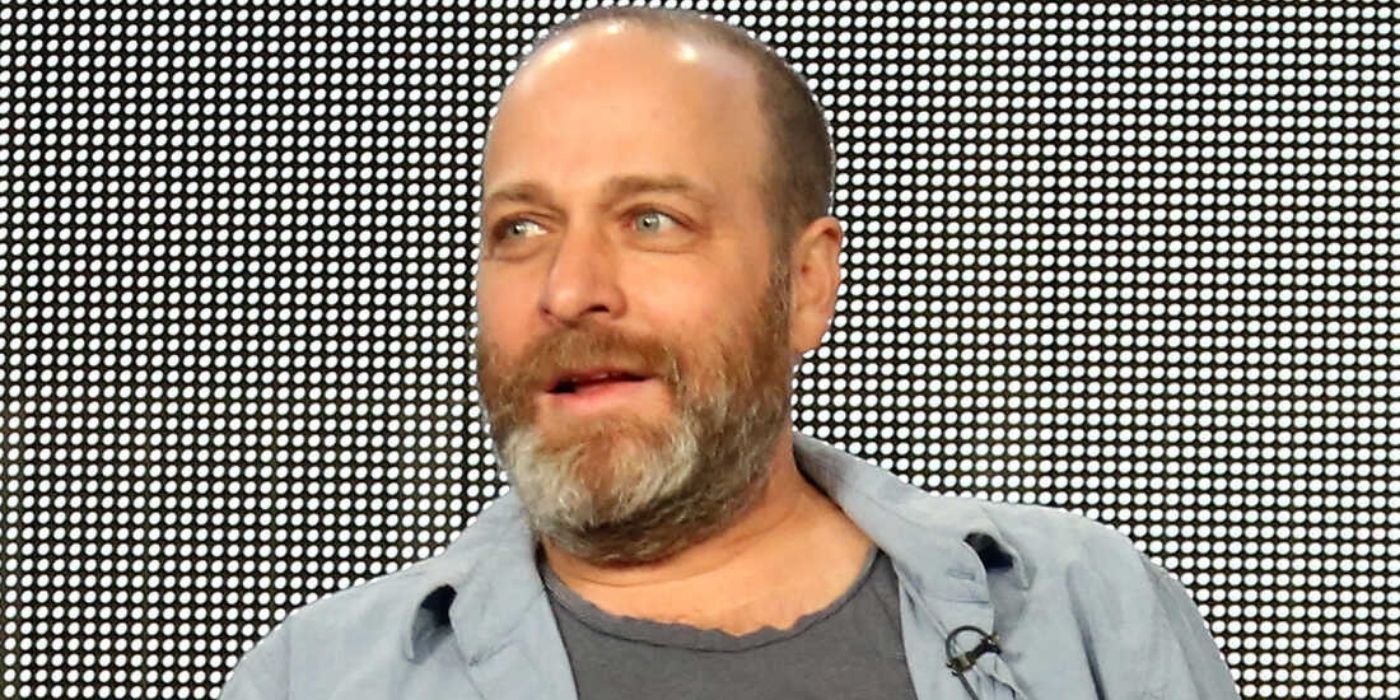 Voice actor H. Jon Benjamin smiling and looking to his side