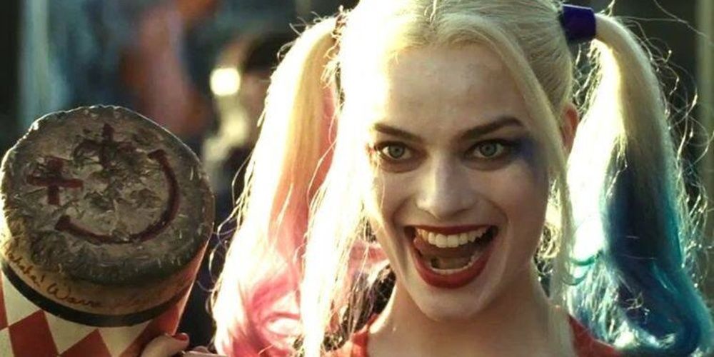 Harley Quinn laughs while holding her mallet in Suicide Squad 