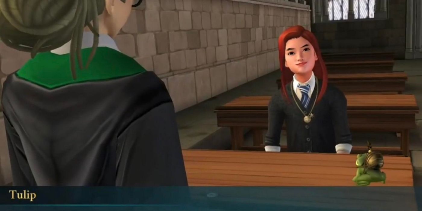 Tulip Karasu sitting behind a desk and smiling in HP Hogwarts Mystery