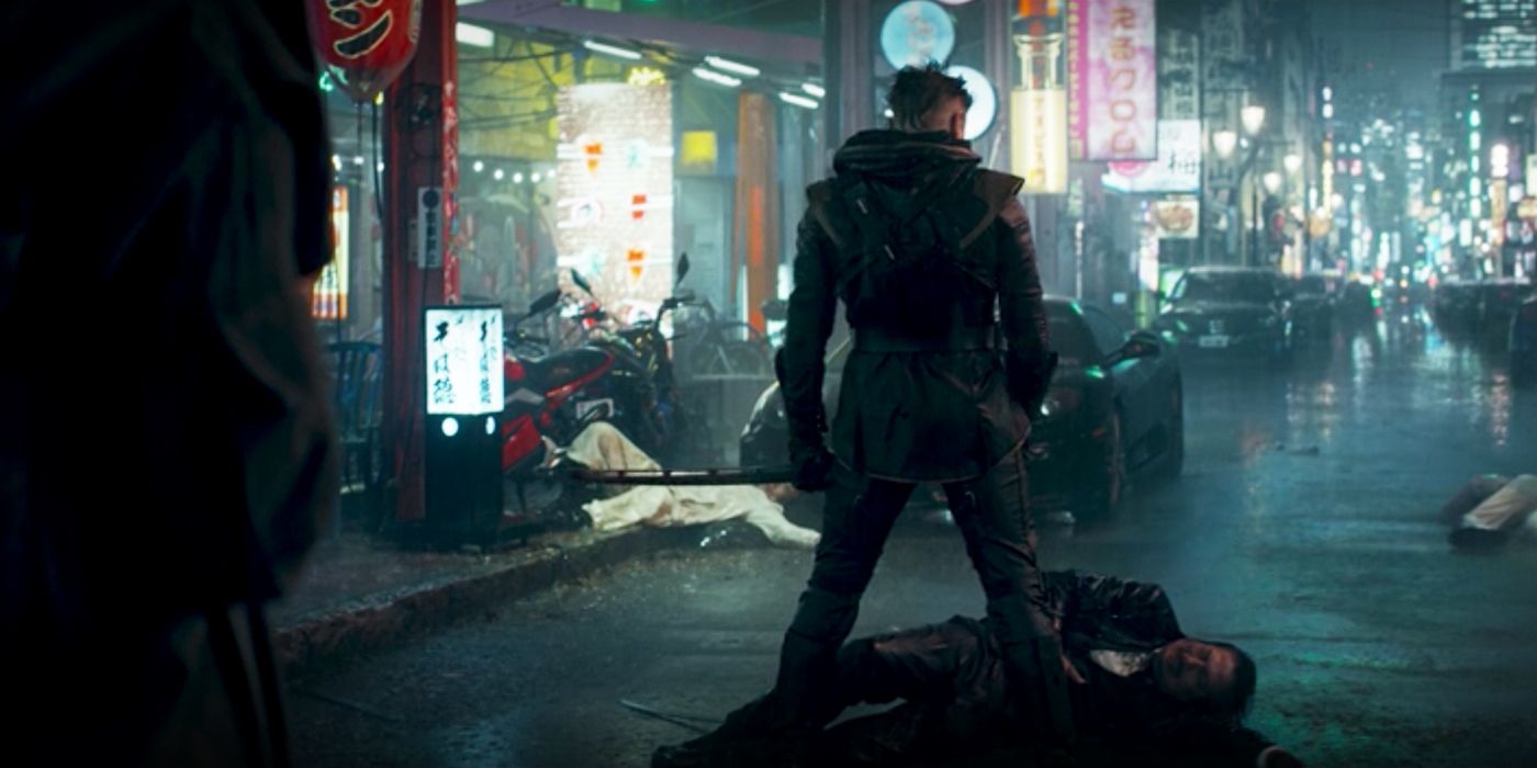 Clint Barton, wearing his Ronin costume, stands over a defeated gangster.