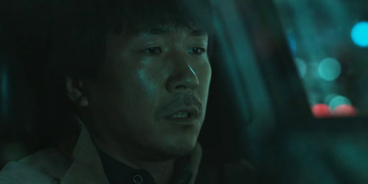 Kyeong-hun sitting in his car in Hellbound.