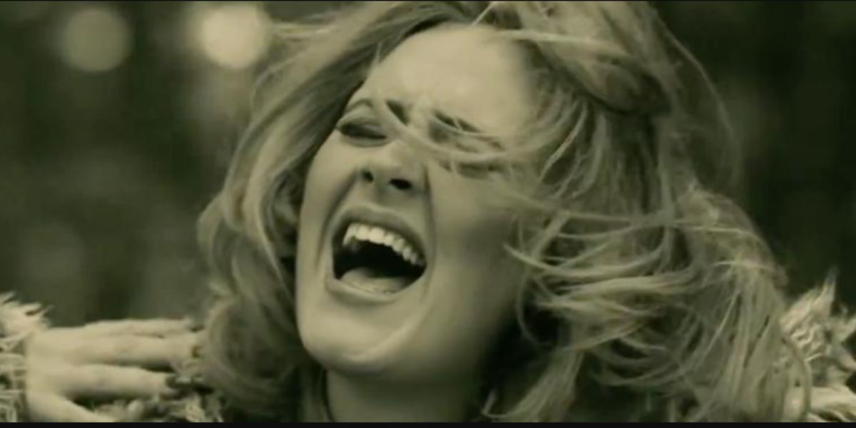 Adele singing with her hair swishing over her face