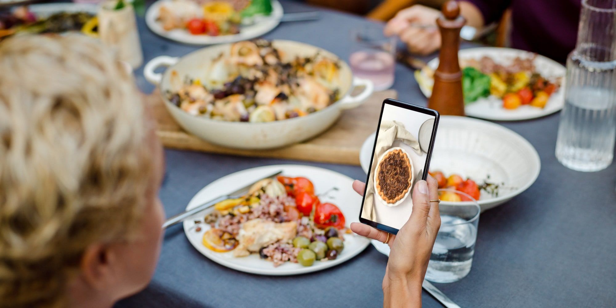 Holiday Meal Photo From Google Blog With a Smartphone Being Held In The Scene
