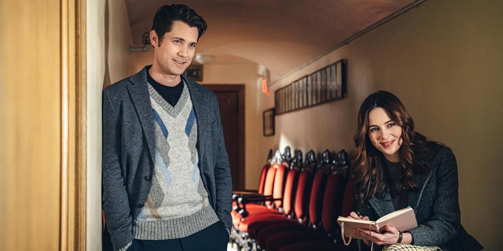 Holly Deveaux and Drew Seeley investigate in a theatre hall in Christmas Movie Magic