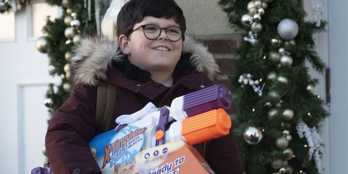 Max smiles while holding a toy gun outside in Home Sweet Home Alone.