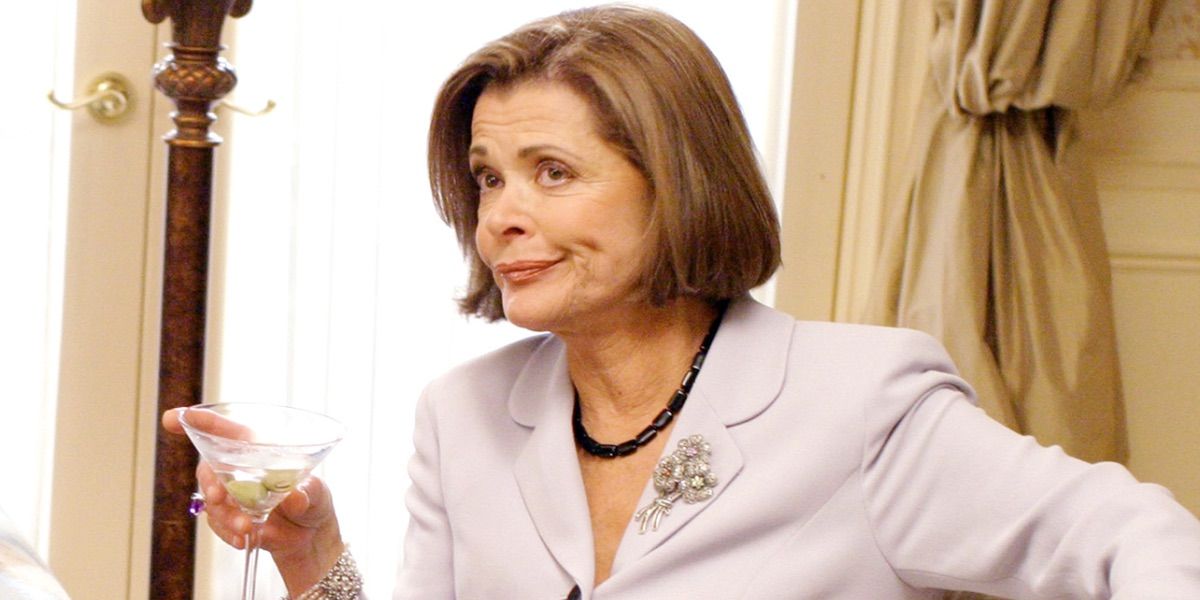 Lucille Bluth holds a martini and smiles in Arrested Development.