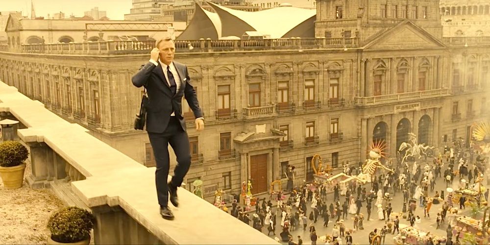 James Bond on a rooftop holding his earpiece in Spectre