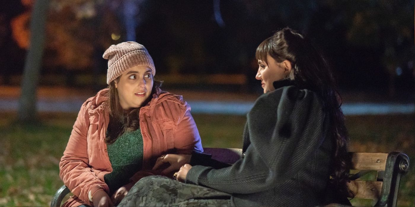 Jenna and Nadja sitting on a bench in What We Do in the Shadows.