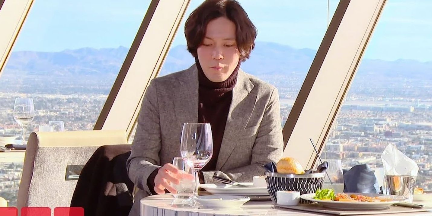 Jihoon from 90 Day Fiance at a restaurant in a turtleneck