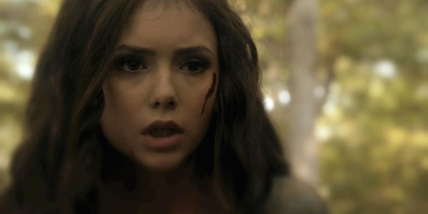 Katherine looks up after finding her family murdered by Klaus