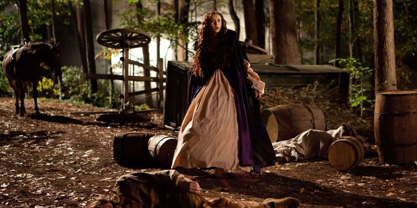 Katerina stands next to a carriage wreckage in The Vampire Diaries 
