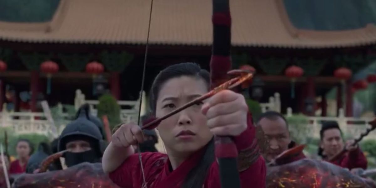 Katie aiming a bow and arrow in Shang-Chi