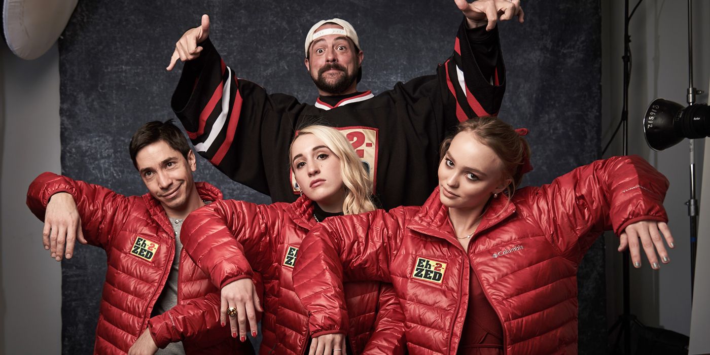 Kevin Smith posing with his Yoga Hosers cast.