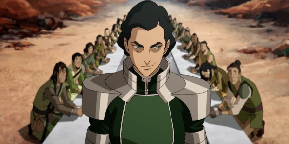 Kuvira smirks as a table full of followers is behind him in Avatar The Last Airbender.