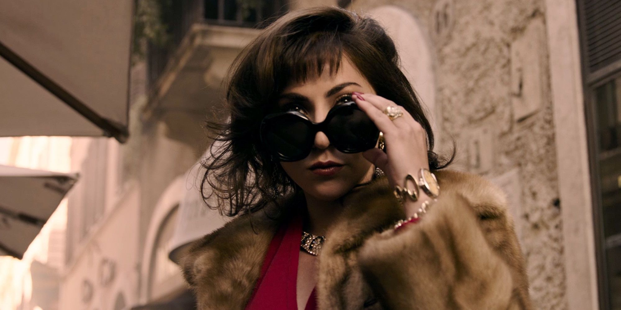 Lady Gaga as Patrizia Reggiani taking off her sunglasses in House of Gucci