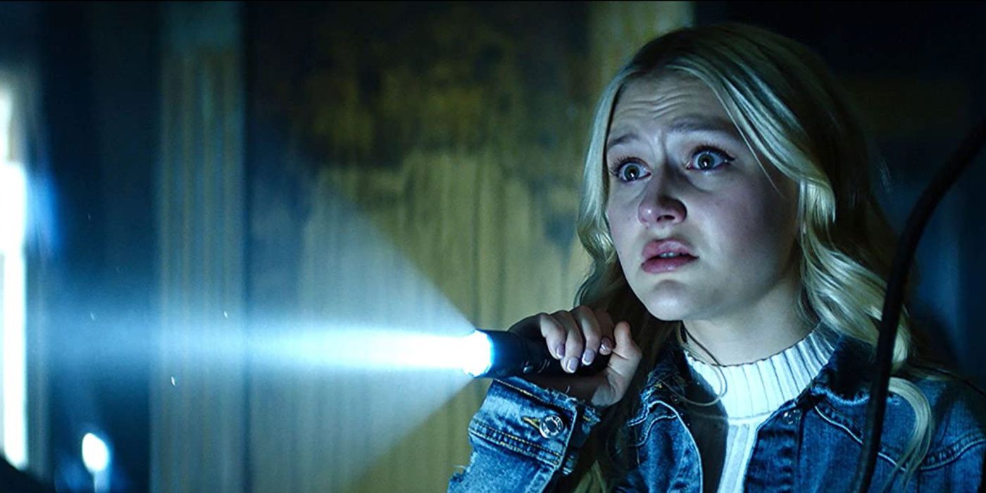 Lexy shines a flashlight in fear on Chucky