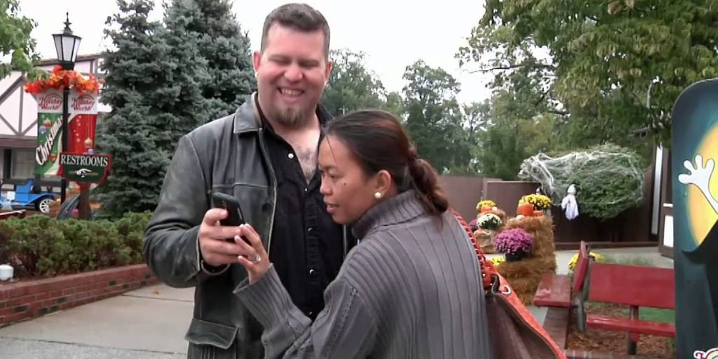 Louis holding phone for Aya to look at in 90 Day Fiance