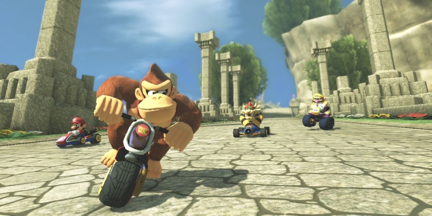 Donkey Kong biking among temple ruins during a race in Mario Kart 8
