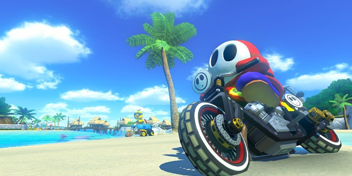Shy Guy on a bike in a beach in Mario Kart 8