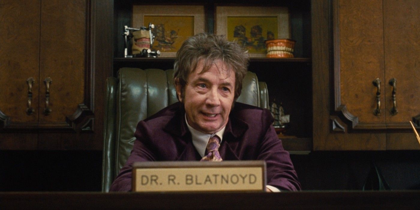 Dr. Rudy Blatnoyd, D.D.S. sits at his desk in Inherent Vice