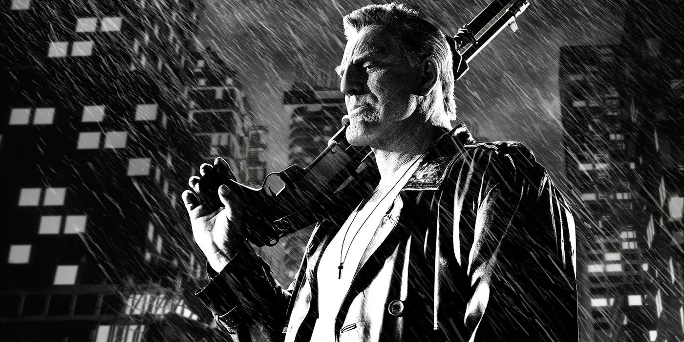 Marv holding his gun in the rain in Sin City.