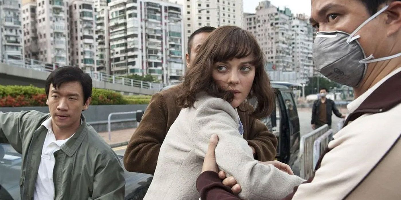 A woman is grabbed by three strange men in Contagion