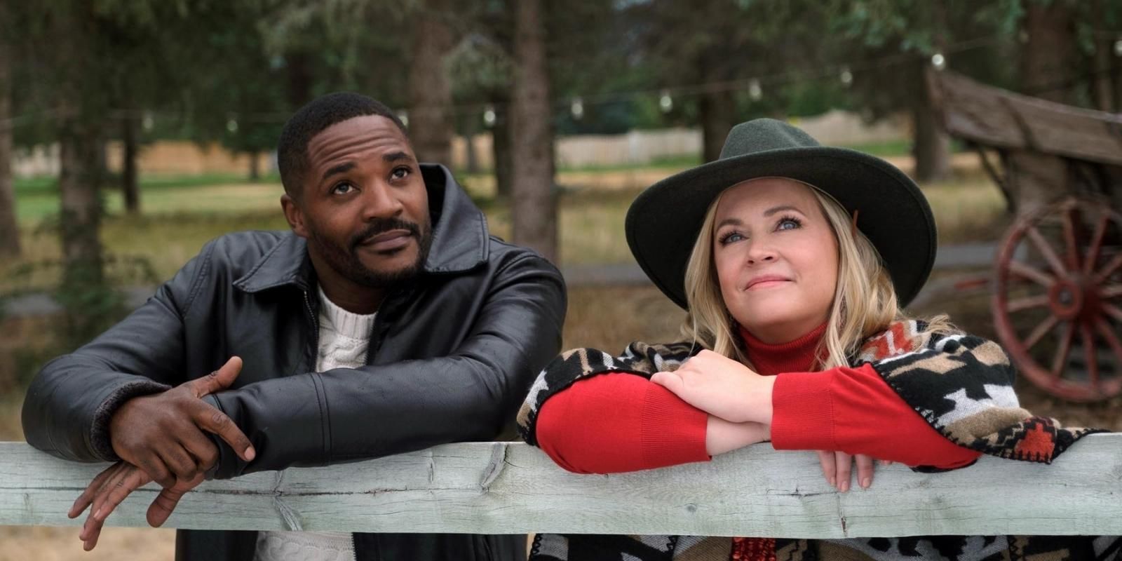 Melissa Joan Hart and Duane Henry pose against a fence on the ranch in Mistletoe in Montana