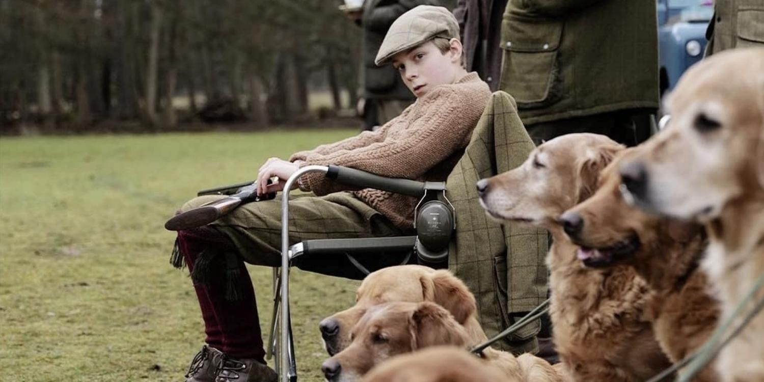 Prince William in hunt clothes surrounded by dogs in Spencer