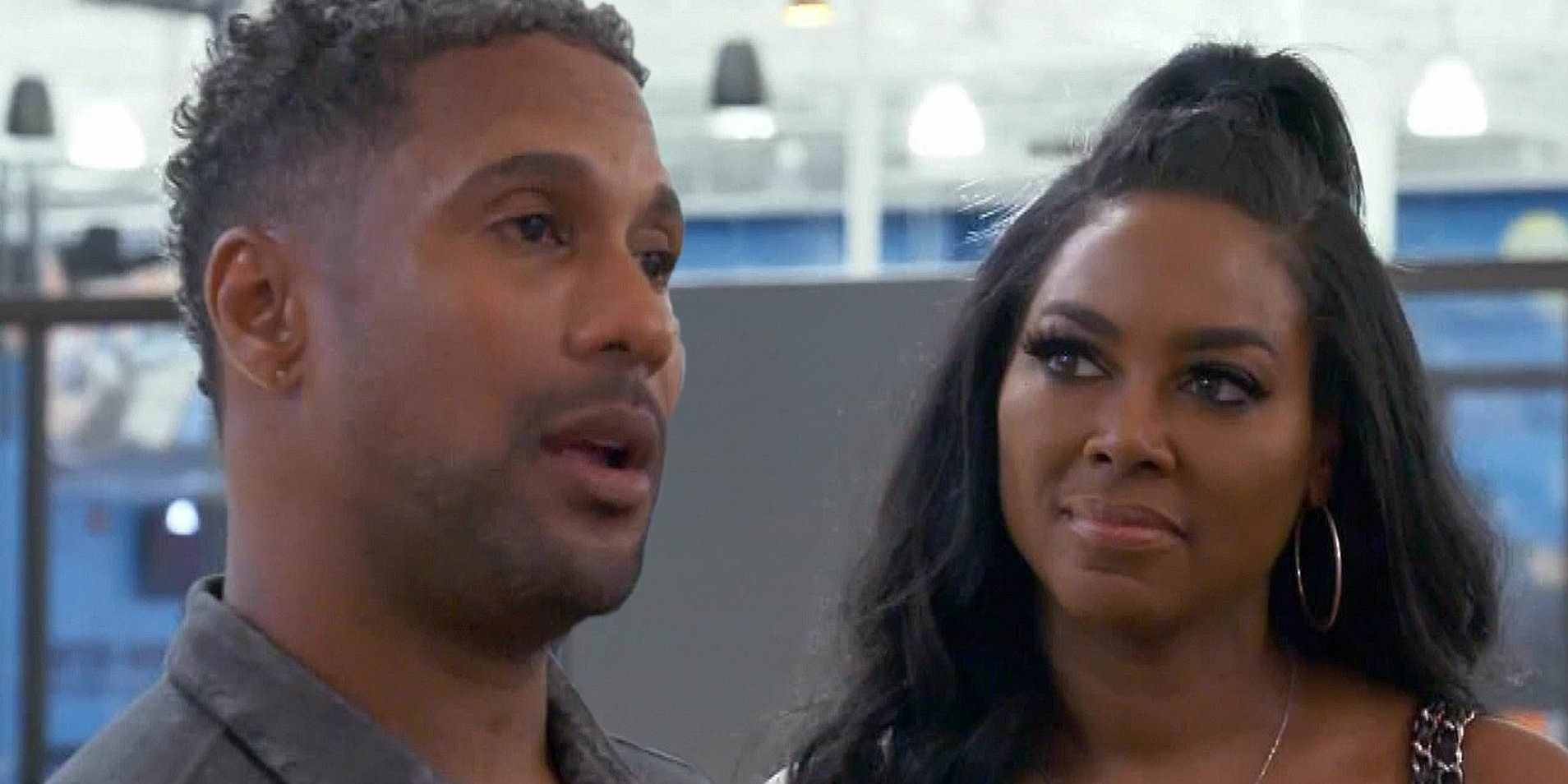 Kenya looks at Marc while he talks to someone off-screen in Real Housewives of Atlanta