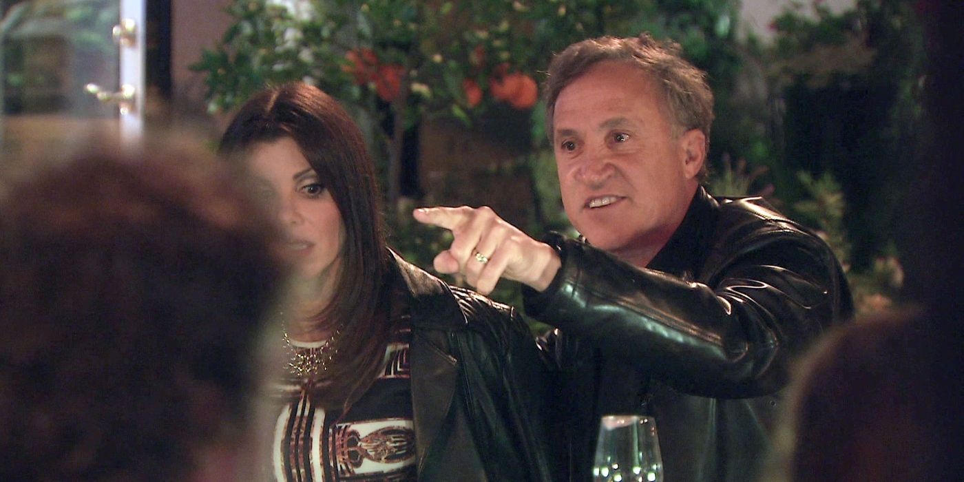 Heather and Terry DuBrow sitting at dinner during a fight on RHOC
