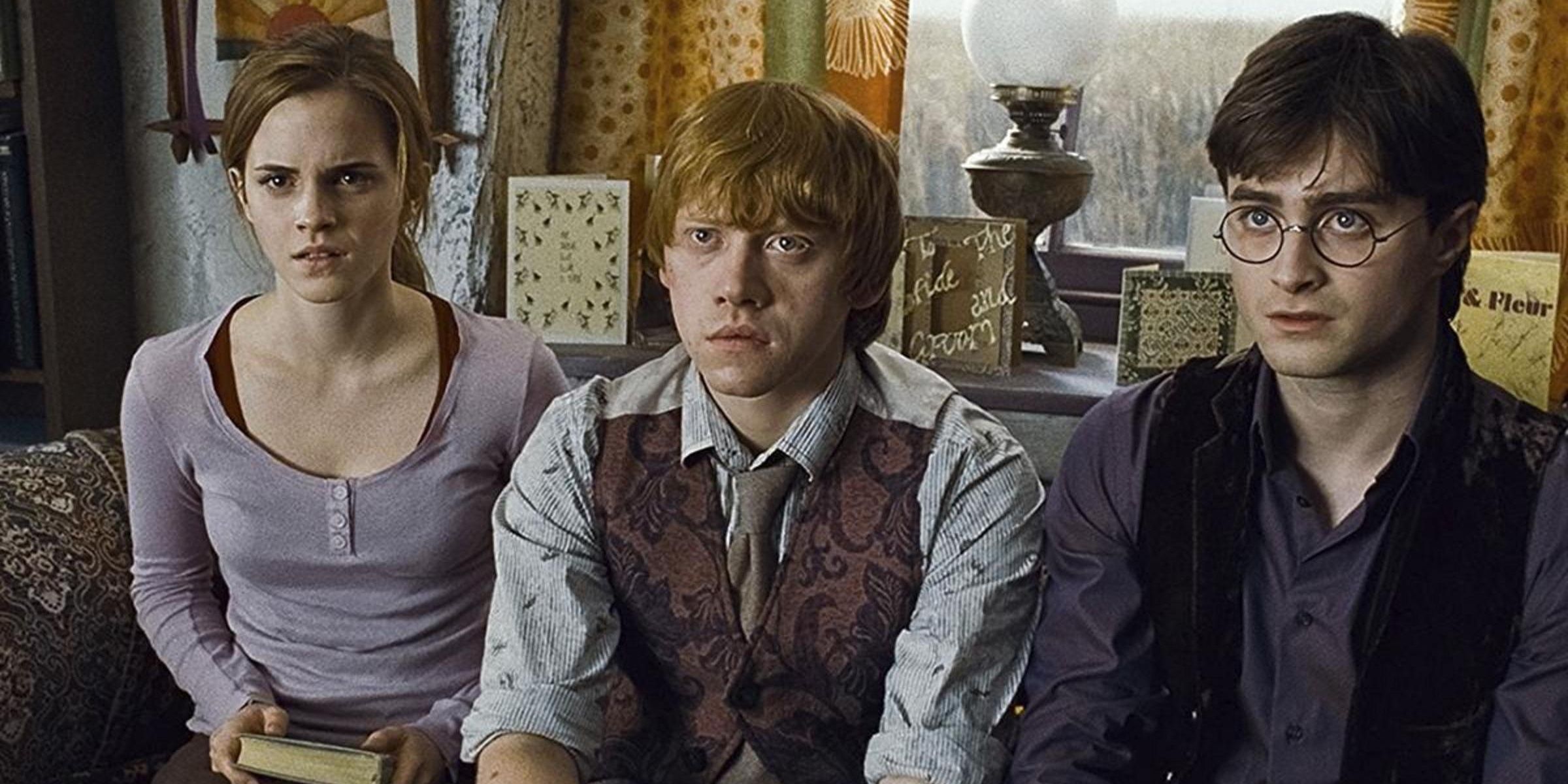 Ron, Hermione, and Harry sit on a couch in Deathly Hallows Part 1 