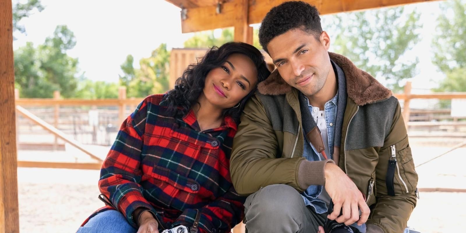 Tatyana Ali and Henderson Wade lean against each other on a bench in A Picture Perfect Holiday