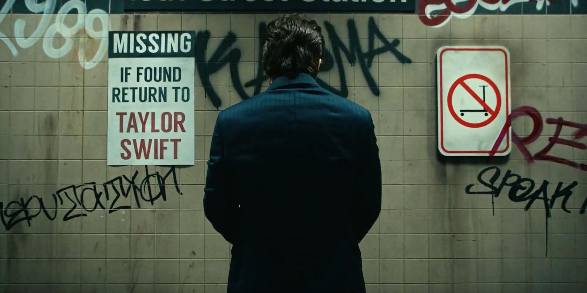Taylor swift pees on a graffitied wall in The Man.