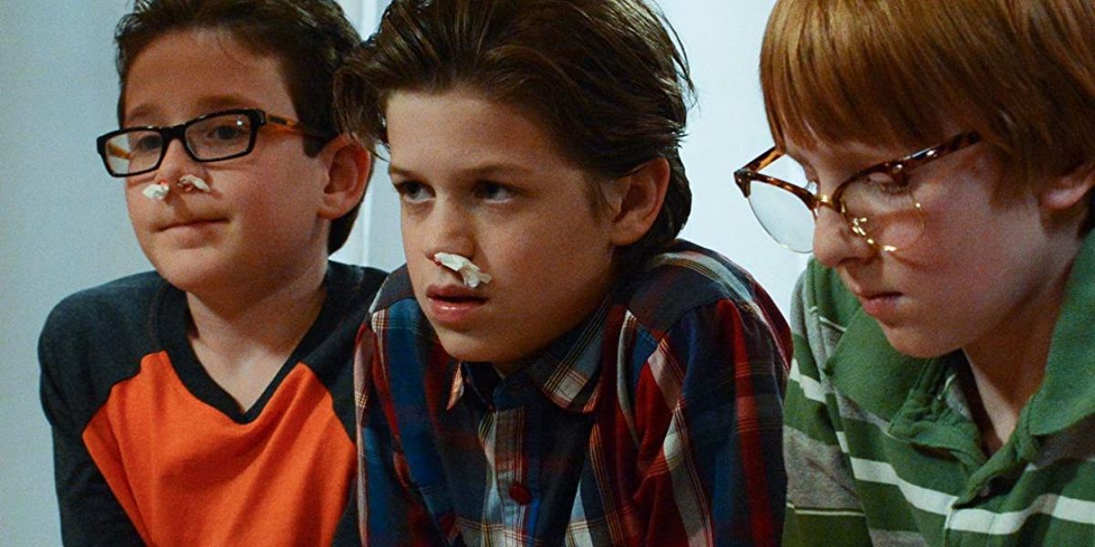 Three boys look on as two of them have bloody noses in The Christmas Project