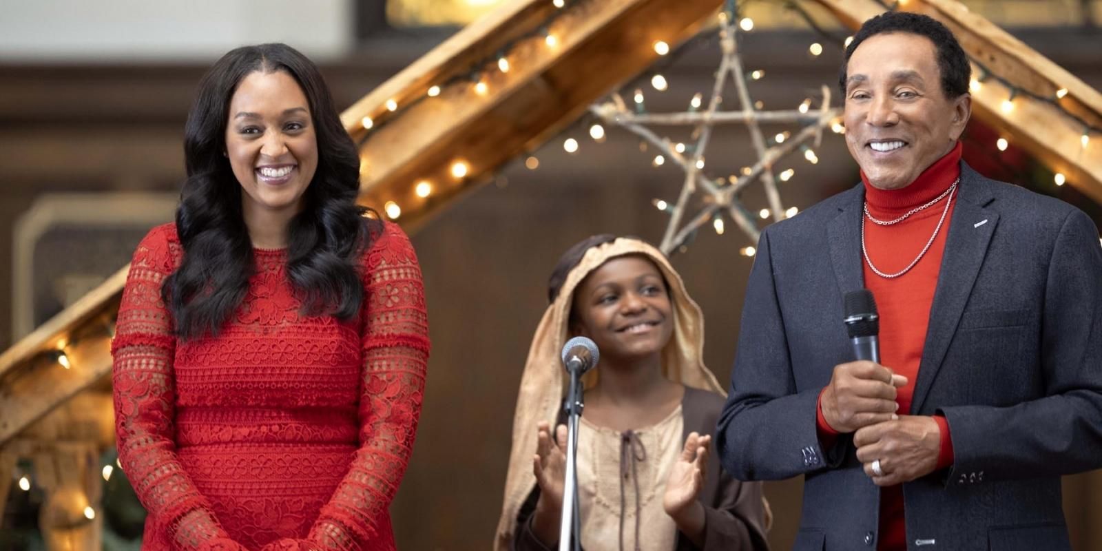 Tamera Mowry and Smokey Robinson smile and perform in a Christmas pageant in Miracle in Motor City