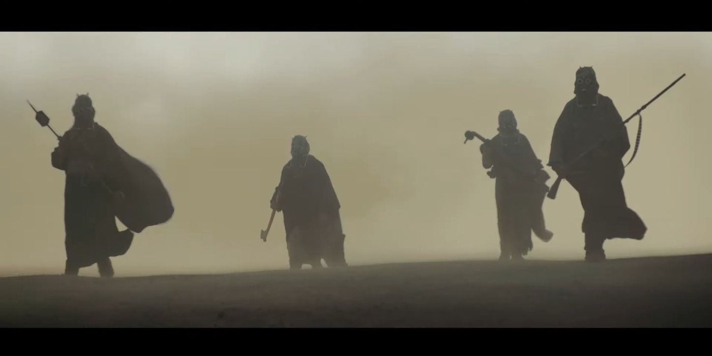 Tusken Raiders walk through the desert in The Book of Boba Fett.